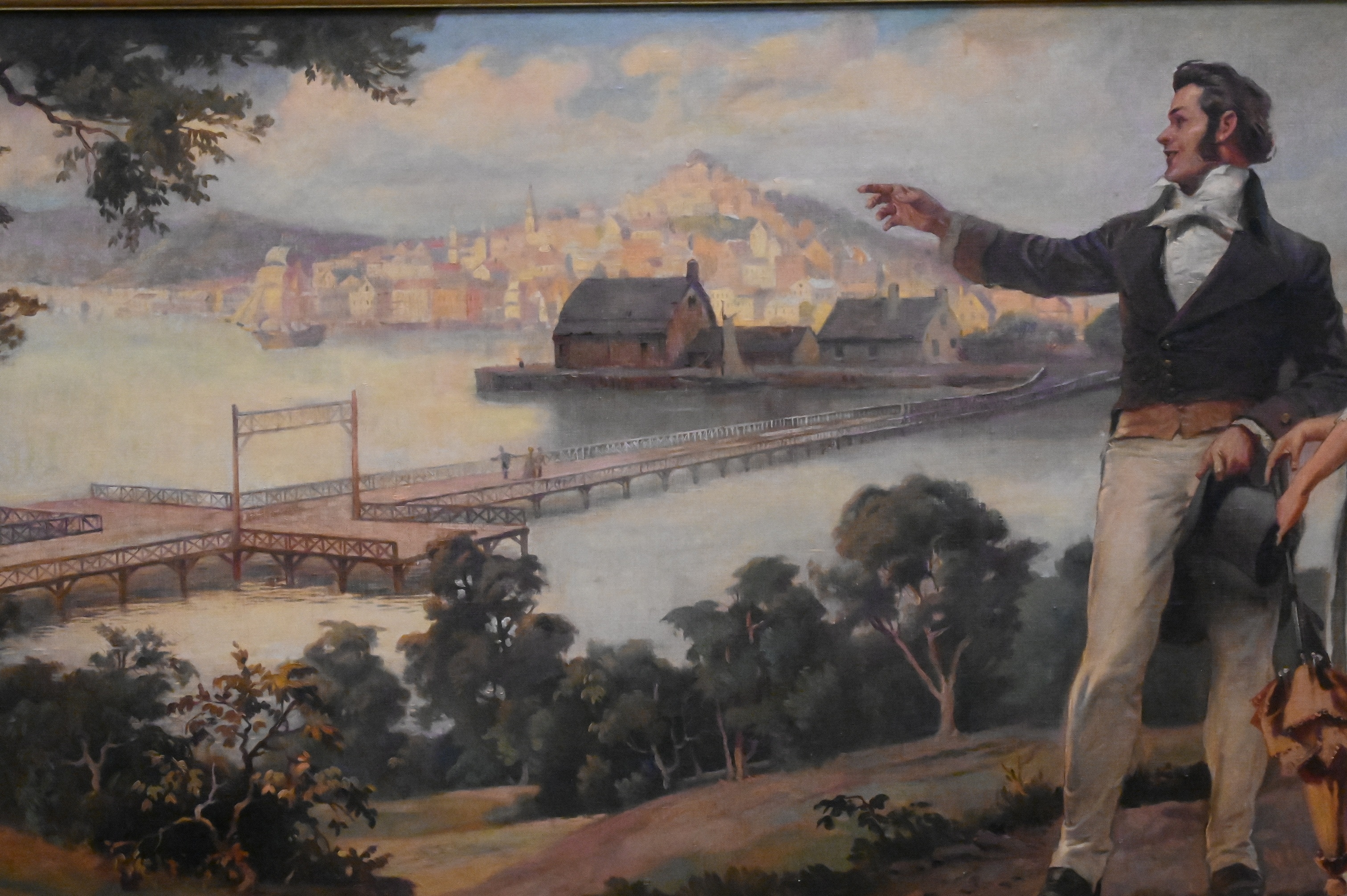 A romanticized landscape painting featuring a couple gazing at a distant city from a hillside.