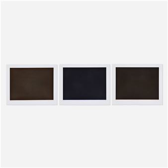 Three polaroid frames on a white wall with a white background.
