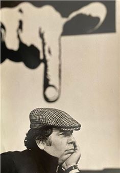 a black and white photo of a man in a hat