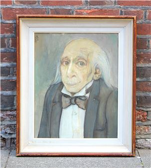 A framed portrait of an elderly man with a bow tie against a brick wall.