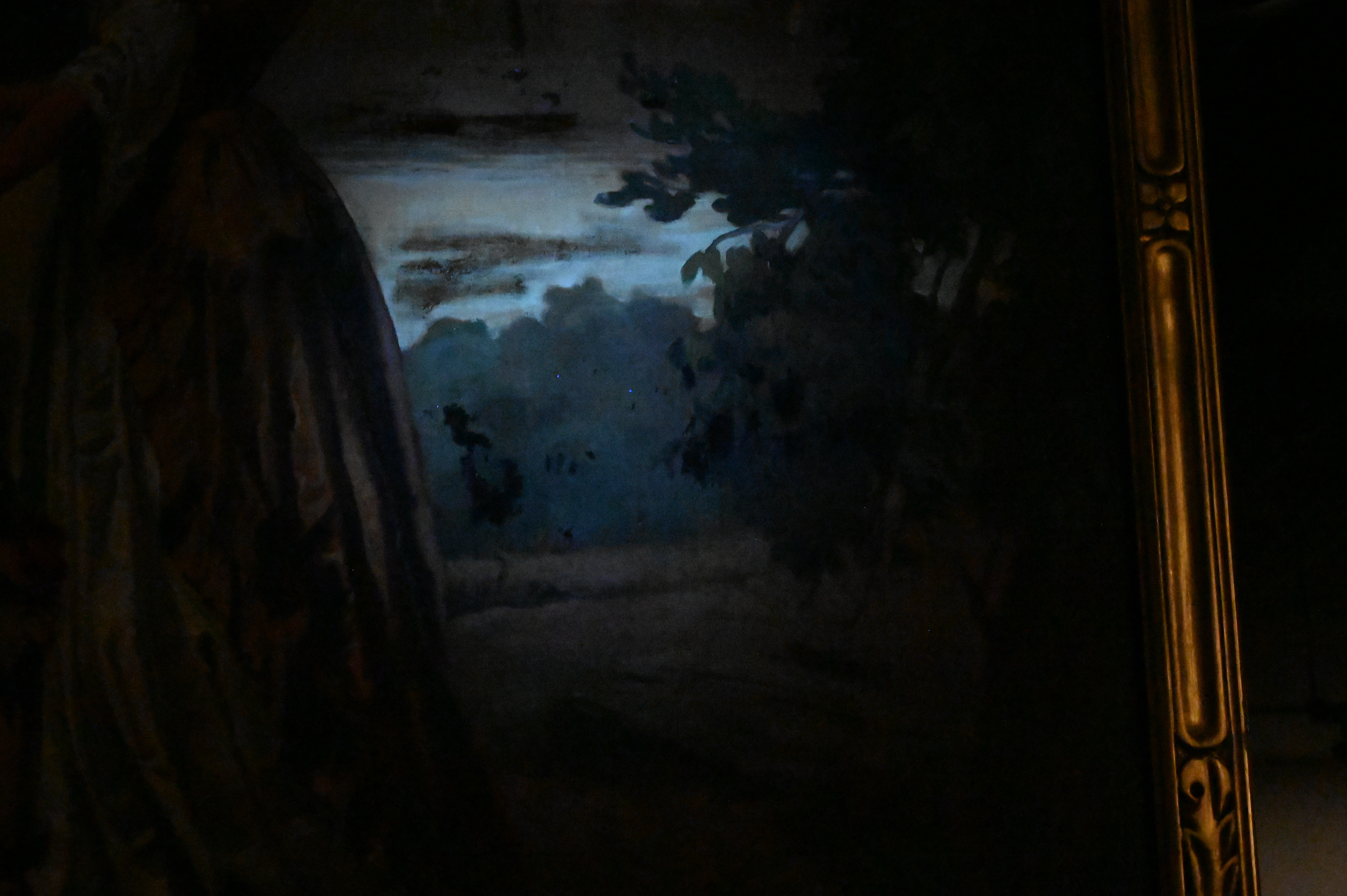 A romanticized landscape painting featuring a couple gazing at a distant city from a hillside.