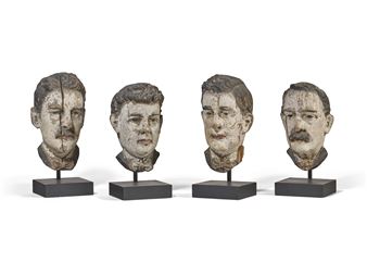 FOUR CARVED PINE AND POLYCHROME PAINT-DECORATED HEADS