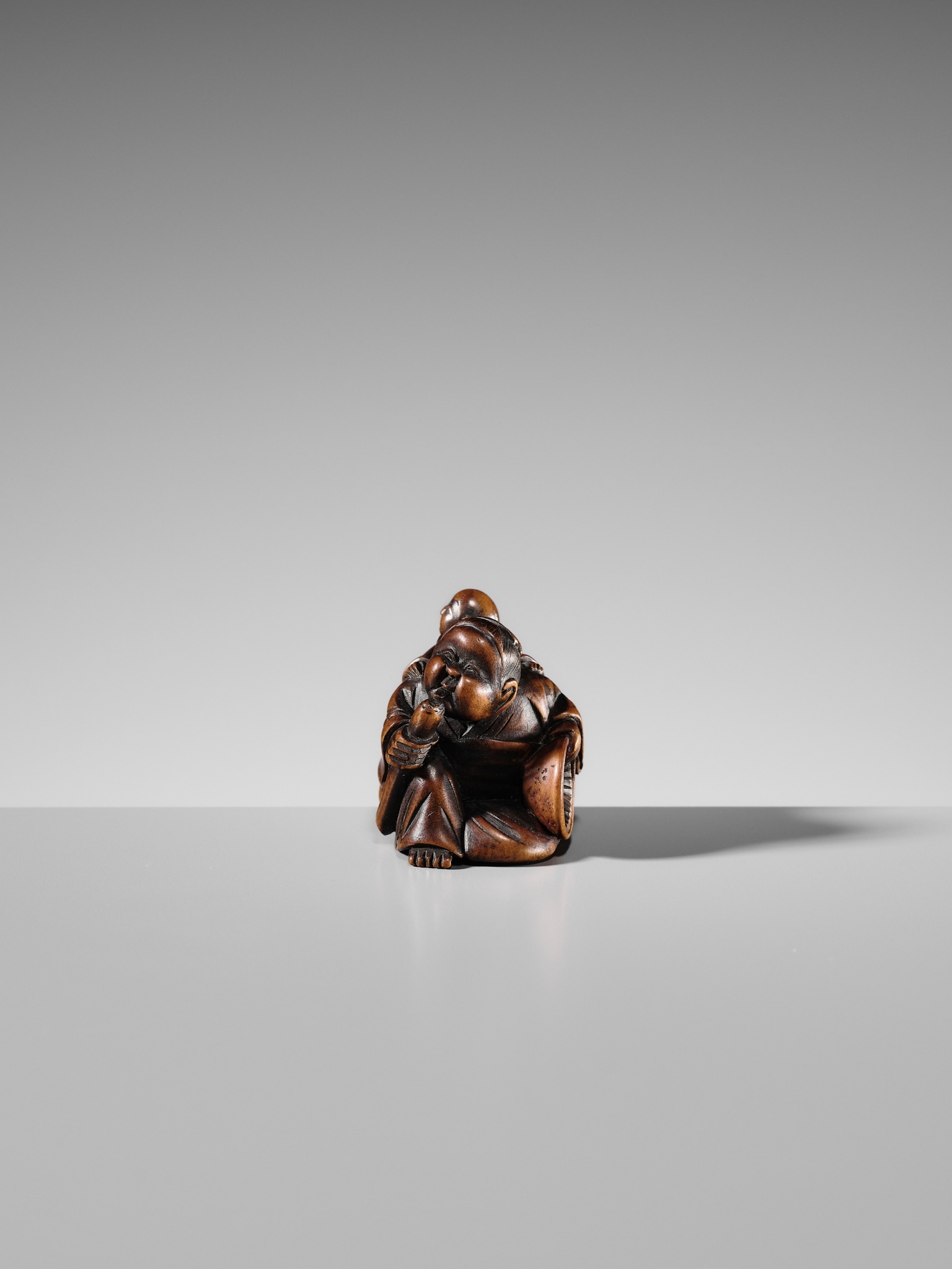 Japanese School, 19th Century | A FINE WOOD SHUNGA NETSUKE OF OKAME ...