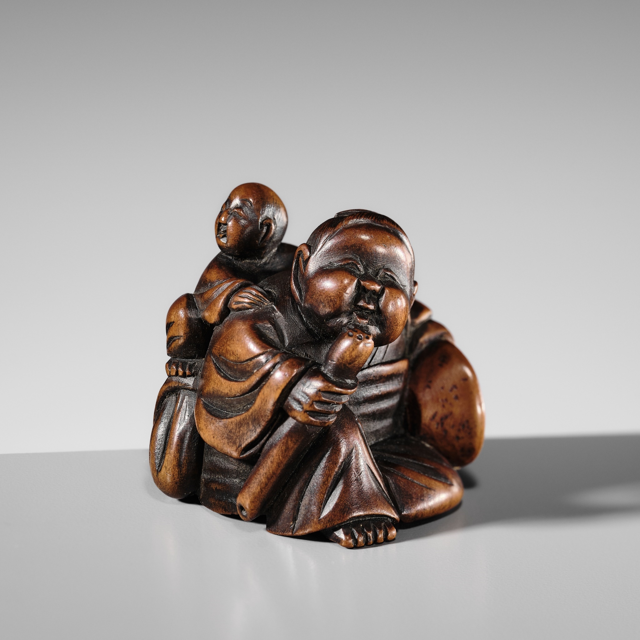 Japanese School, 19th Century | A FINE WOOD SHUNGA NETSUKE OF OKAME ...