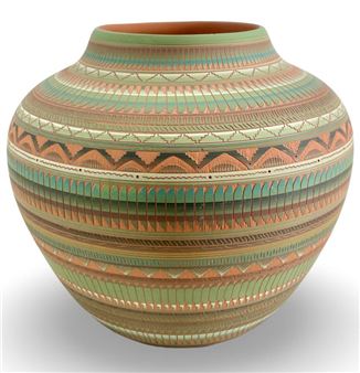 A green and brown vase sitting on top of a white surface.