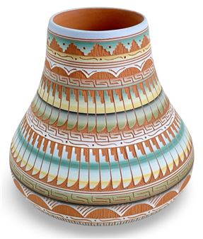 A vase that is sitting on top of a white surface.