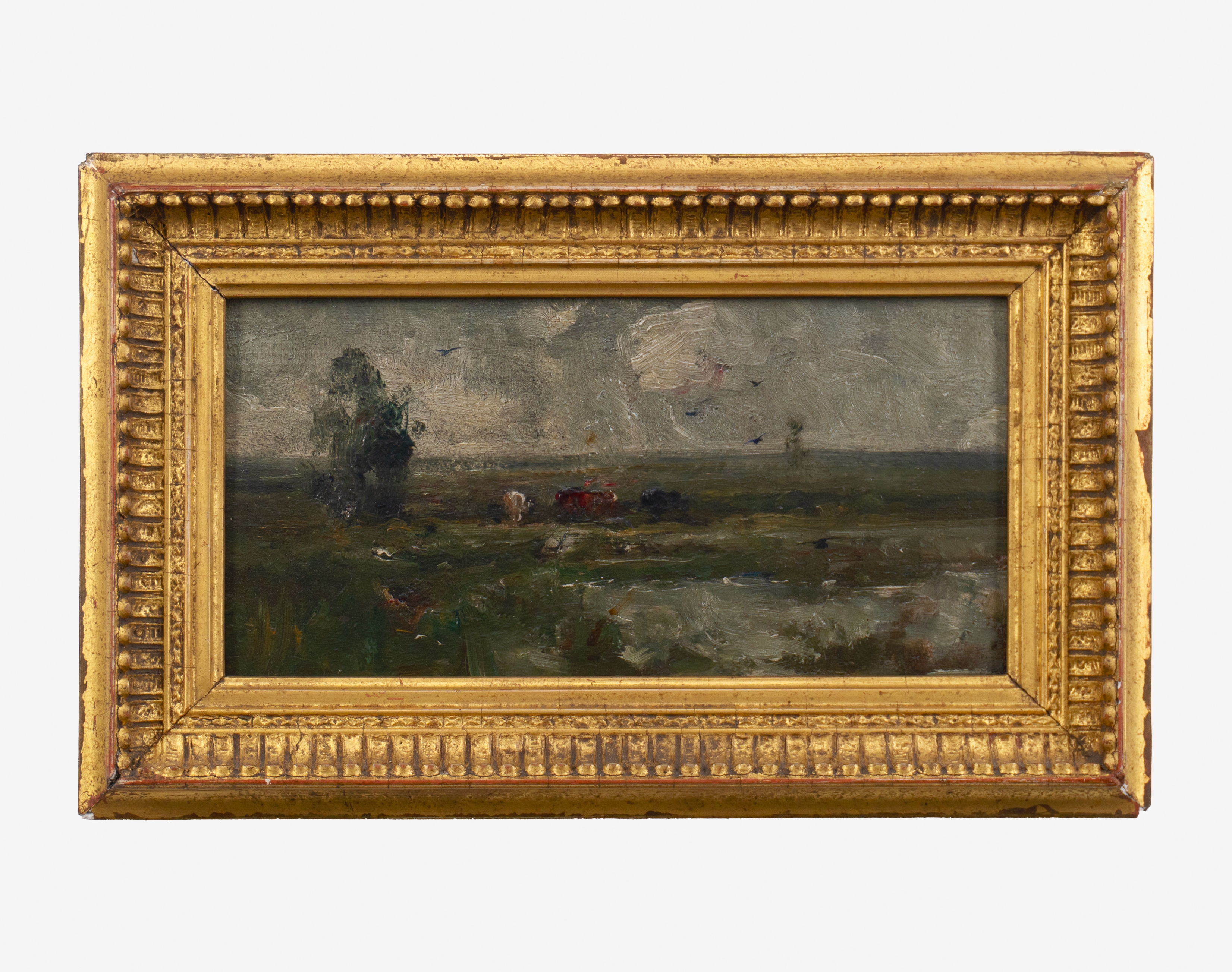 A small landscape painting in a gilded frame depicting a pastoral scene with cattle and a distant tree.