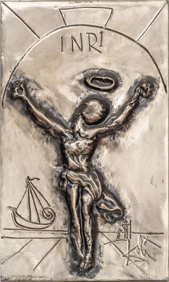 A metallic relief sculpture of a crucified figure with the inscription INRI above, featuring a small boat and cross in the background.