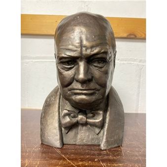 A bronze bust of a man with a bow tie.
