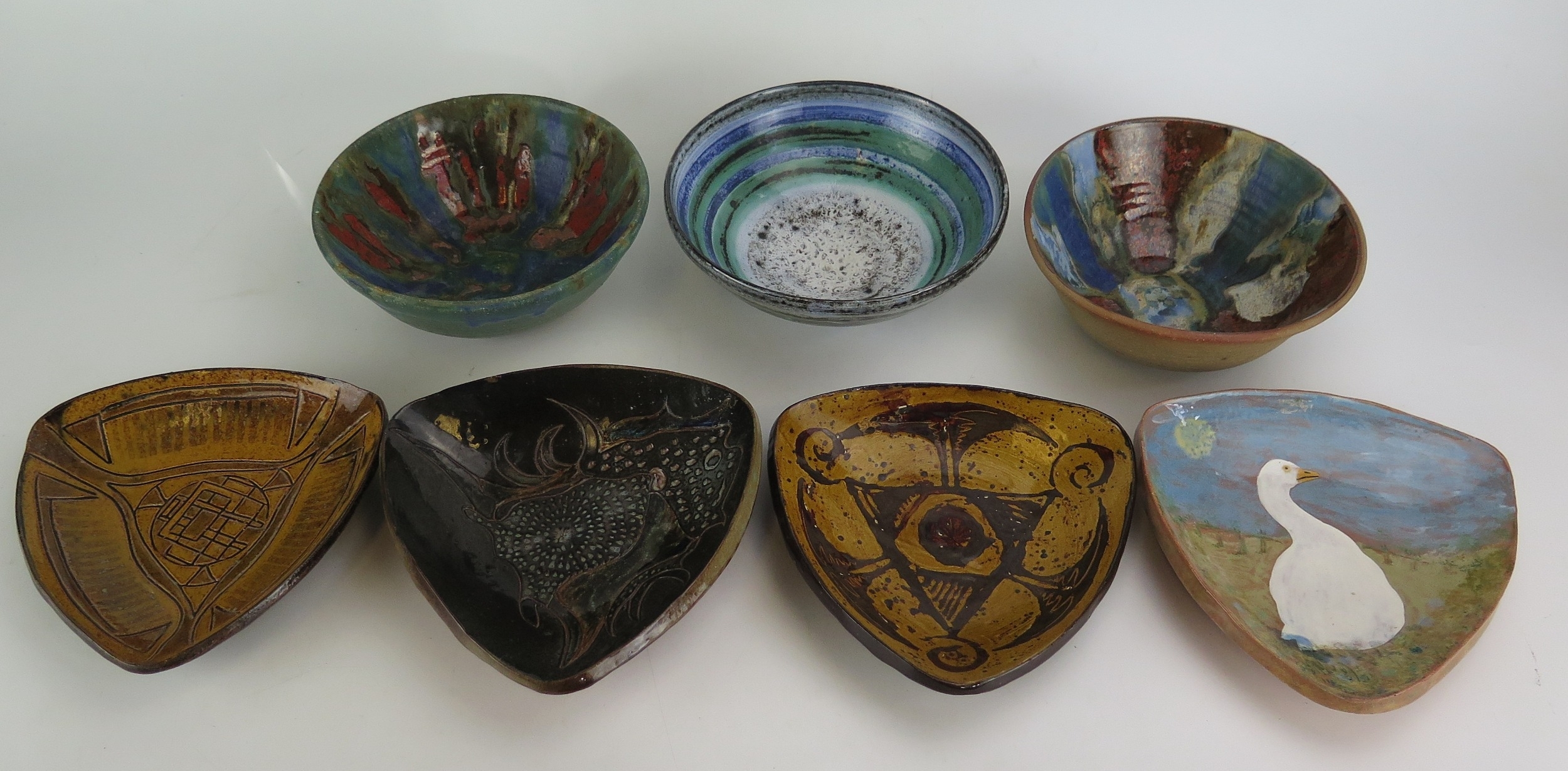 Betty Nesbitt | four pottery triangular plates decorated with fish ...