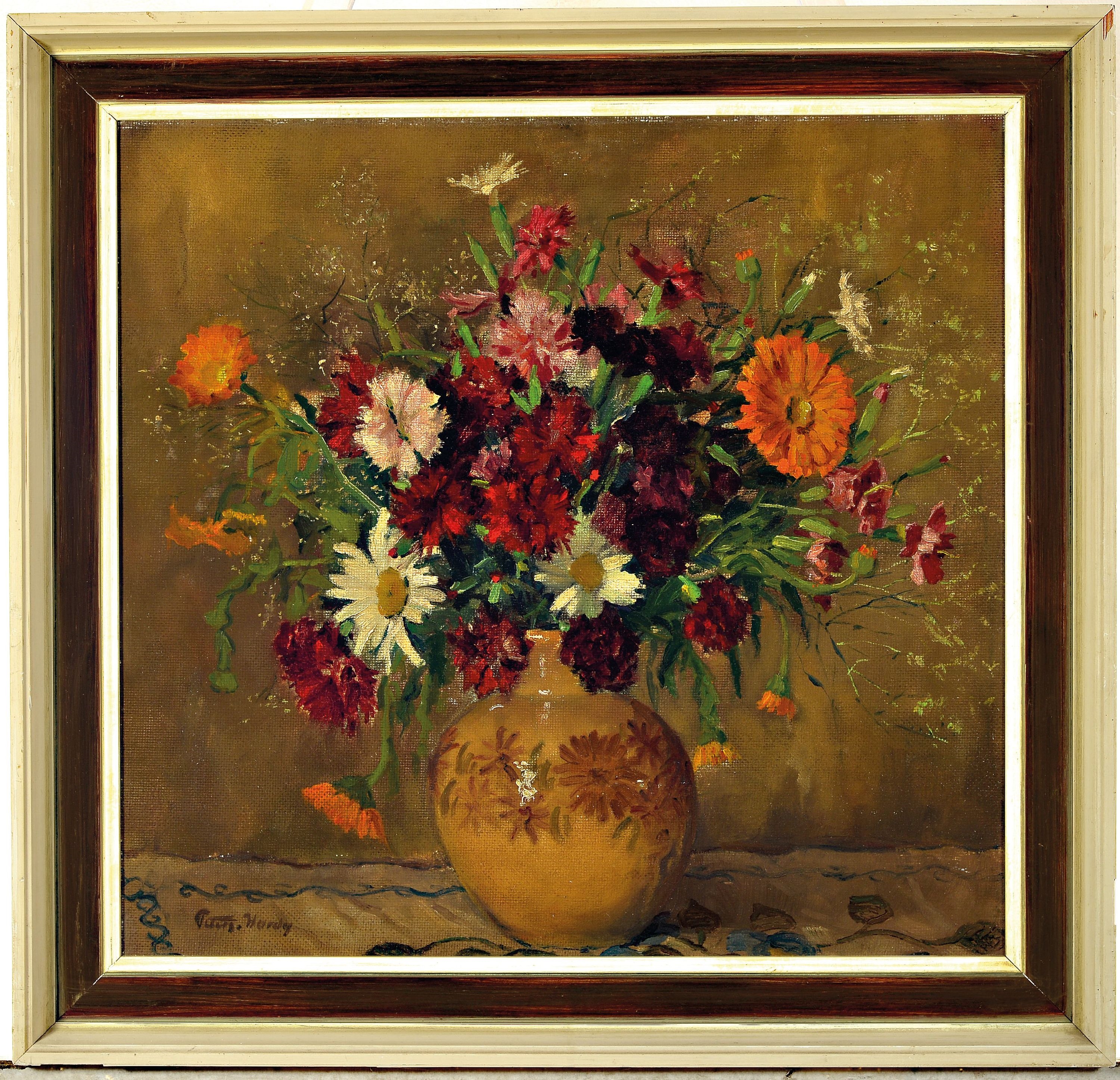 A vibrant floral arrangement in a patterned vase against a textured background.
