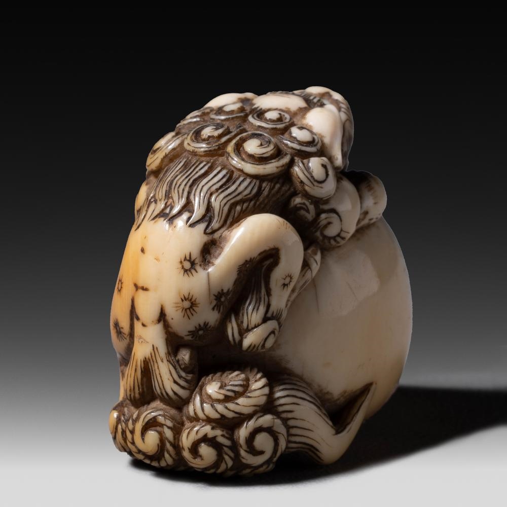 Japanese School, 19th Century | A Japanese ivory netsuke of a shishi on ...