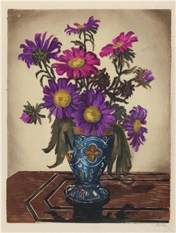A still life of purple and pink daisies in a blue patterned vase on a wooden table.