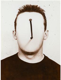 A man with a nail sticking out of his face.