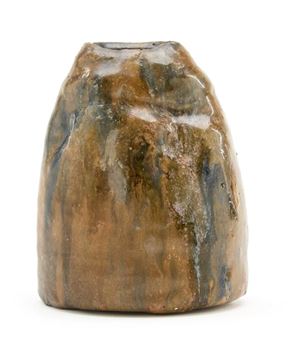 A brown vase sitting on top of a white surface.