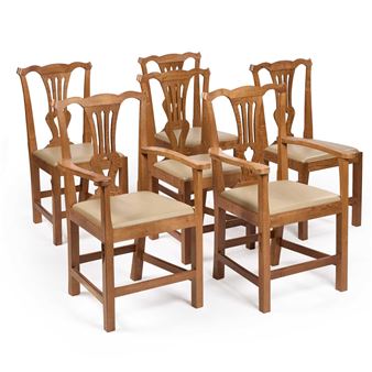 A set of six wooden dining chairs with upholstered seats arranged in a group against a plain white background.
