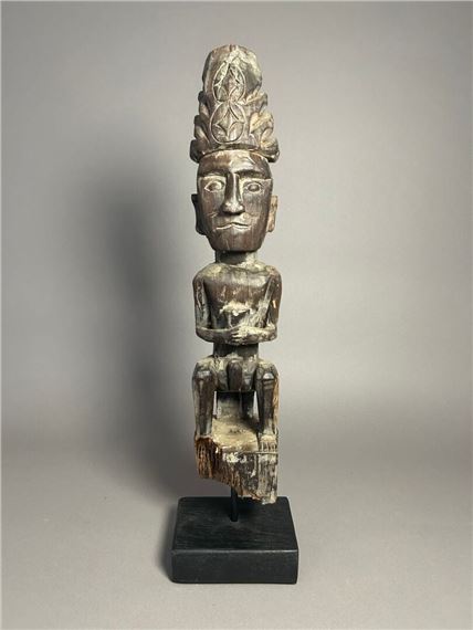 Adu Zatua statue, Nias Island, Indonesia. Seated figure of an ancestor holding a cup by Indonesian School, 20th Century, Early 20th century