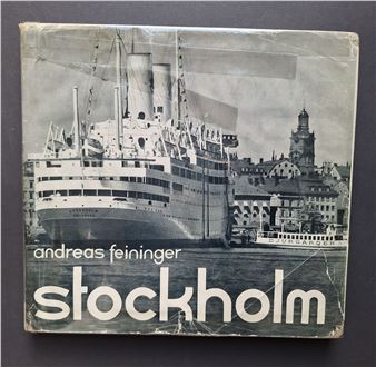 A book with a picture of a ship in the background.