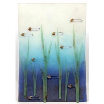 A vertical mixed-media artwork featuring tall green blades and scattered safety pins against a blue gradient background.