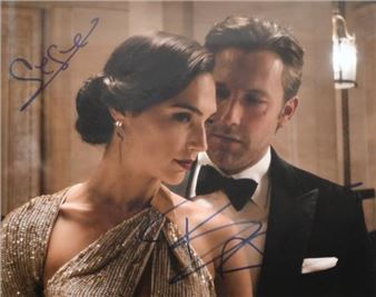 a man and a woman in formal attire posing for a picture