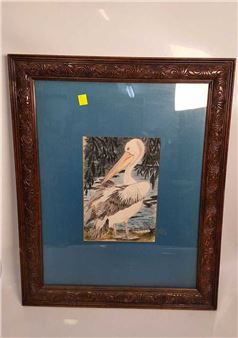 A framed watercolor painting of a pelican against a blue background.
