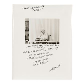 A black-and-white photograph of a seated figure surrounded by handwritten text on a white background.