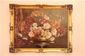 A classical still life painting of a vibrant floral arrangement in an ornate golden frame.