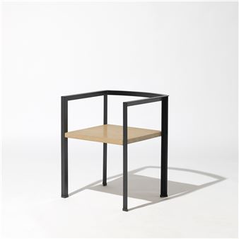 A minimalist chair with a light wooden seat and black metal frame against a stark white background.