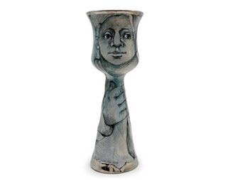 a vase with a drawing of a woman's face on it