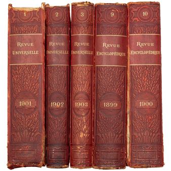 A collection of five vintage leather-bound books standing upright in a row.