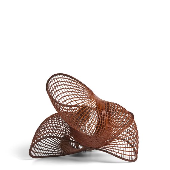A sculptural chair with a woven, lattice-like structure in warm brown tones.