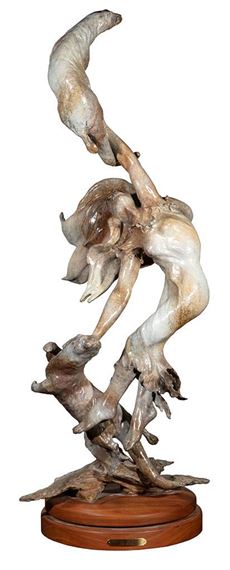 a bronze sculpture of a woman holding a baby in her arms