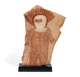 A painted stone slab featuring a stylized human figure with geometric patterns.