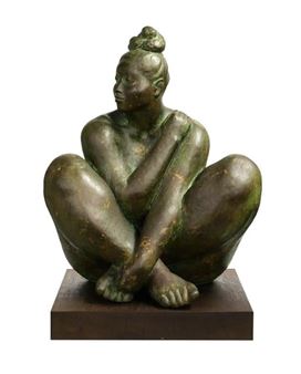 A bronze sculpture of a seated figure with a contemplative expression.