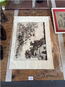 A monochromatic ink drawing of a seated figure in a landscape, displayed on a wooden table.