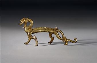 A VERY RARE AND IMPORTANT GILT-BRONZE FIGURE OF A STRIDING DRAGON