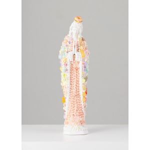 A tall, textured ceramic figure resembling a robed figure with colorful floral embellishments.