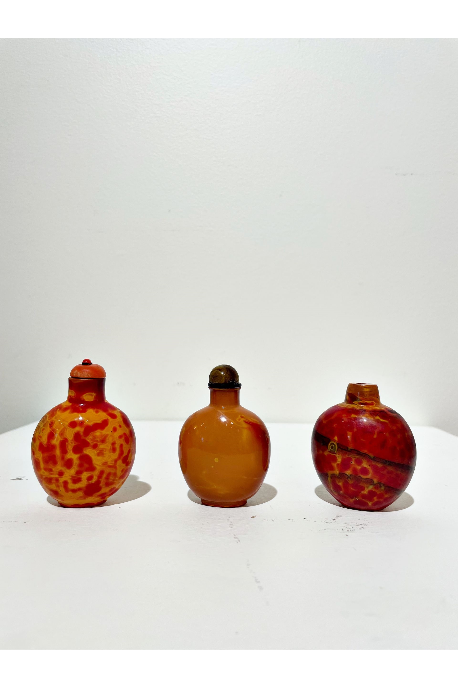 Chinese School | THREE REALGAR GLASS SNUFF BOTTLES | MutualArt