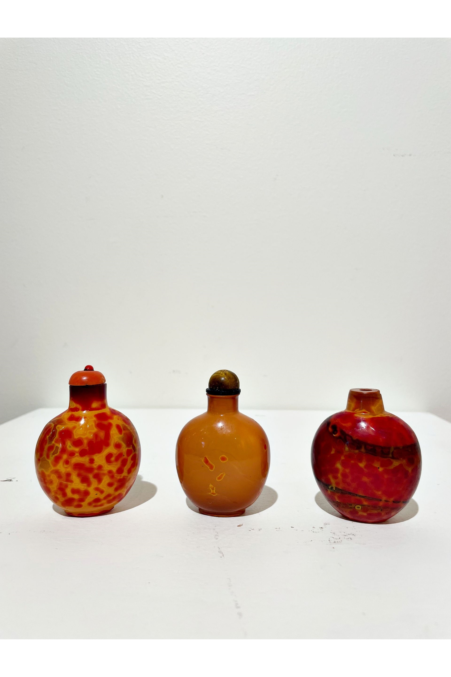 Chinese School | THREE REALGAR GLASS SNUFF BOTTLES | MutualArt