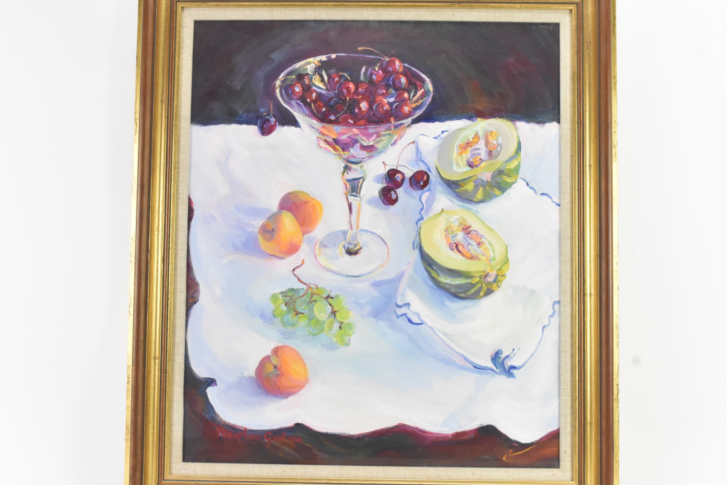 A still life painting featuring a glass bowl of red fruit and halved melons on a white cloth.