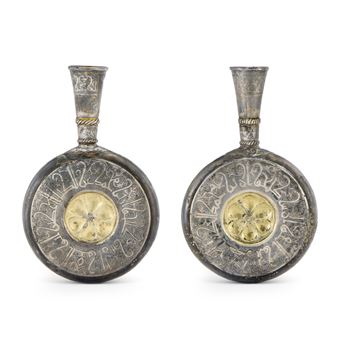 A PAIR OF GILT AND NIELLOED SILVER PILGRIM FLASKS