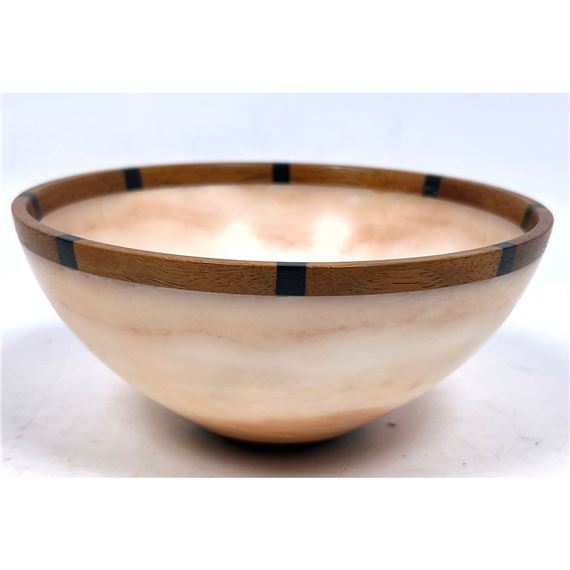 A wooden bowl sitting on top of a white table.
