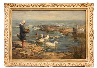 A person in a dark dress and bonnet stands on rocky shores feeding swans near the ocean.