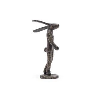 A bronze sculpture of a rabbit standing on its hind legs with long ears and a textured surface.