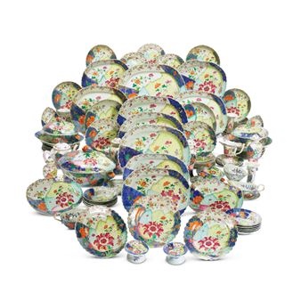 A Large and Extensive Chinese Export 'Tobacco Leaf' Part Dinner Service, A large oval tureen, cover and two stands,  A pair of oval tureens, covers and stands,  A pair of sauce tureens and covers,  Two massive oval platters, Two large oval platters, Four medium oval platters  Two smaller oval platters,   A pair of large circular saucer dishes, Four smaller saucer dishes,  A pair of salt...