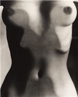 A black-and-white photograph of a torso with heavy shadows and motion blur.
