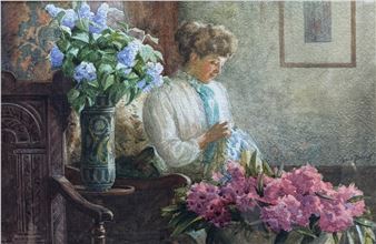 A woman in a white blouse sits quietly amidst vibrant blue and pink flowers.