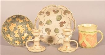 A collection of five ceramic tableware pieces featuring floral and leaf motifs.