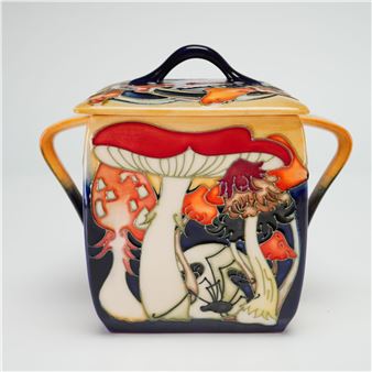 A ceramic sugar bowl featuring a vibrant, stylized forest scene with mushrooms and a fox.