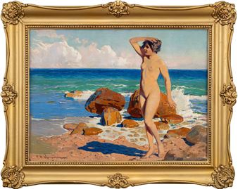 A nude figure stands on a rocky beach with the ocean in the background.